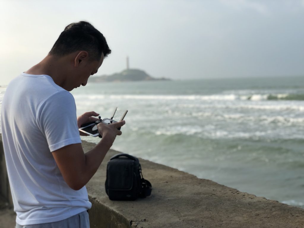 Operating a drone film on Ke Ga Beach, Vietnam