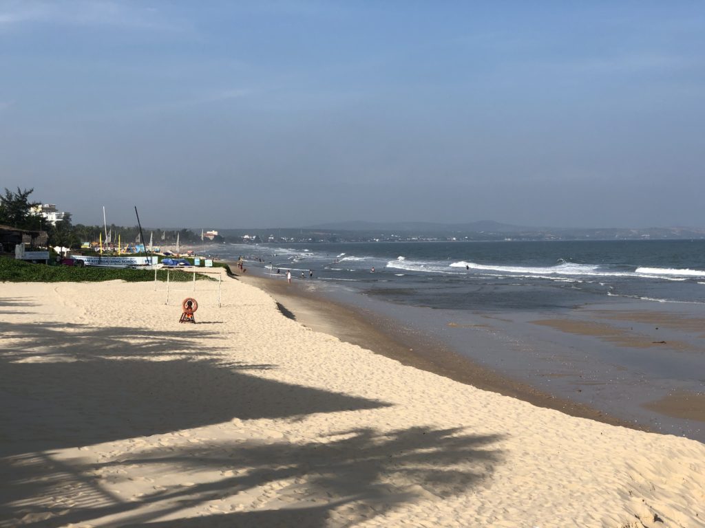Phan Thiet Beach at low tide, with coastal erosion
