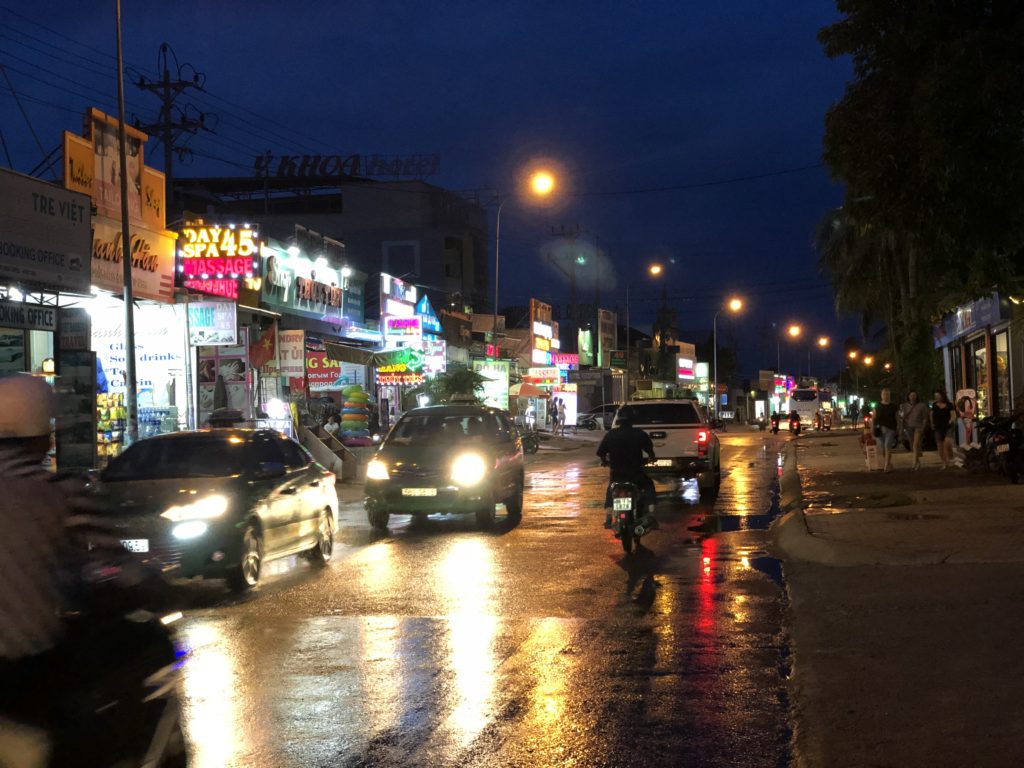 Phan Thiet Beach road at night with lights from massage parlours and pharmacies