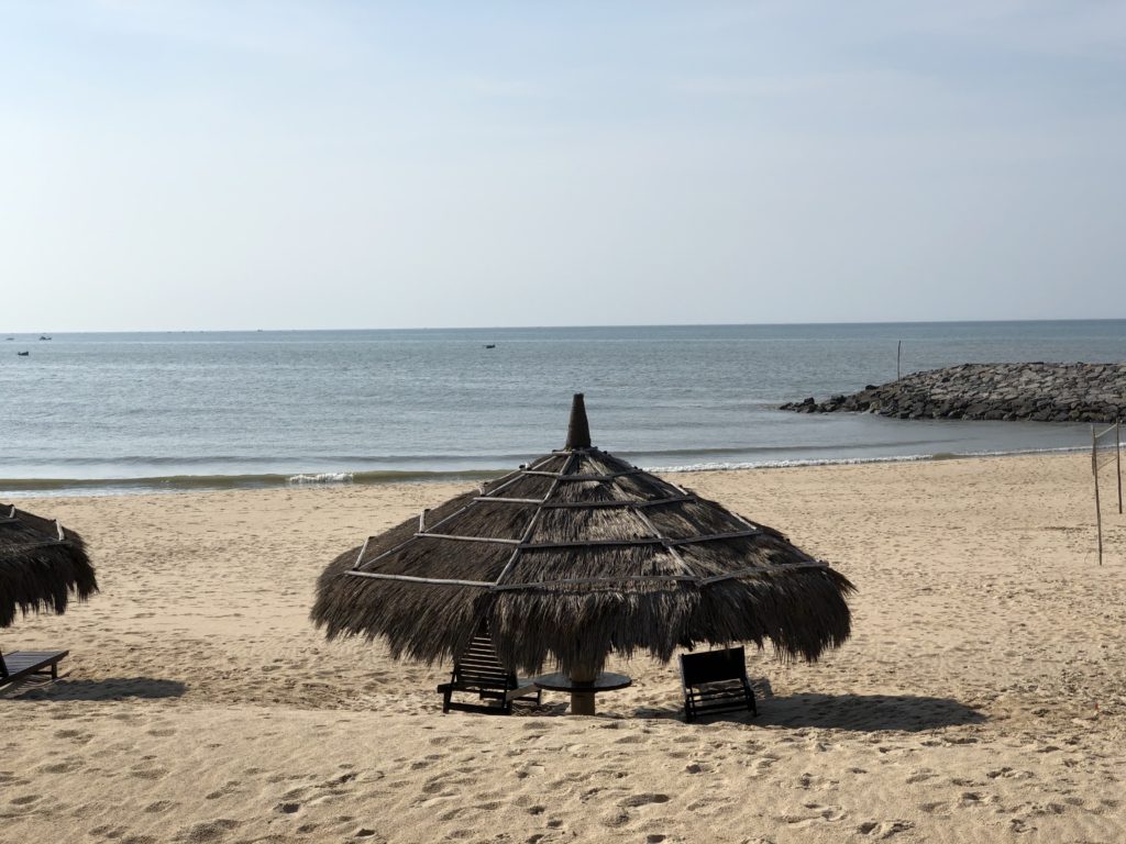 Phan Thiet Beach Resort with rows of straw beach parasols