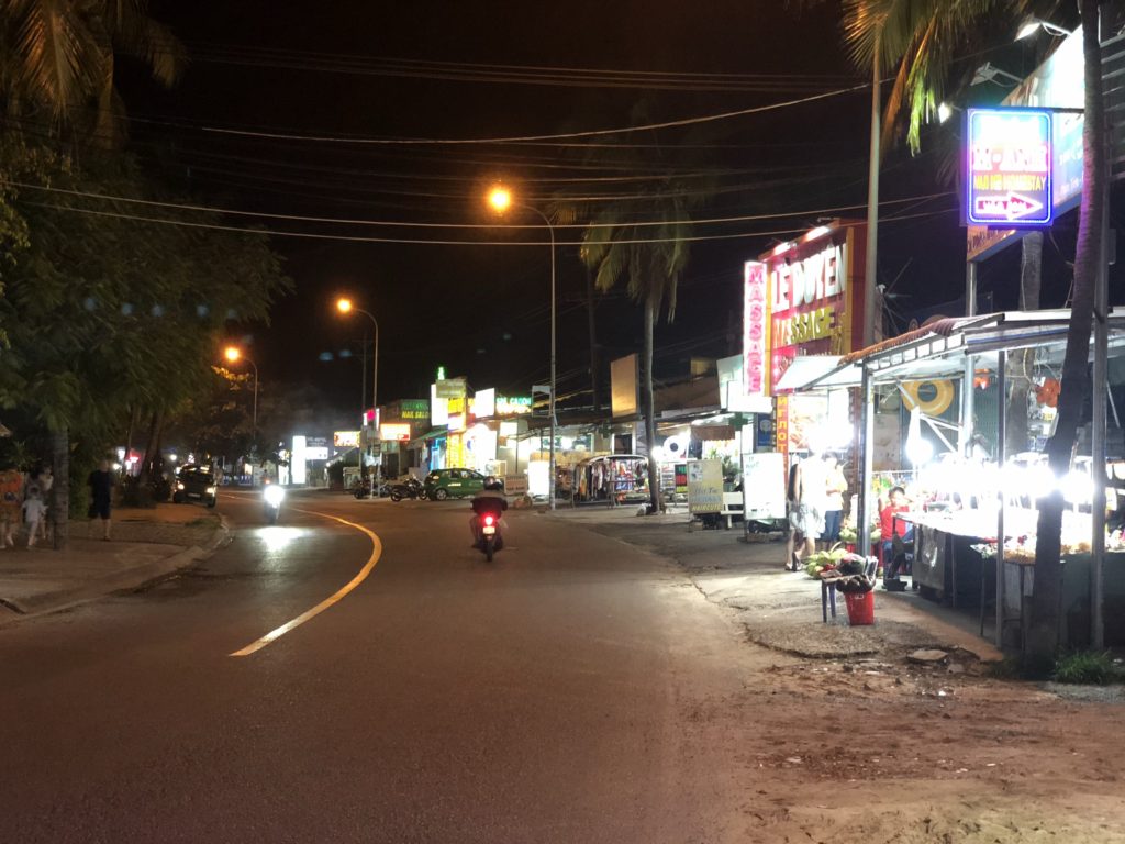 Phan Thiet Beach Street at night. Many massage parlours and pharmacies.