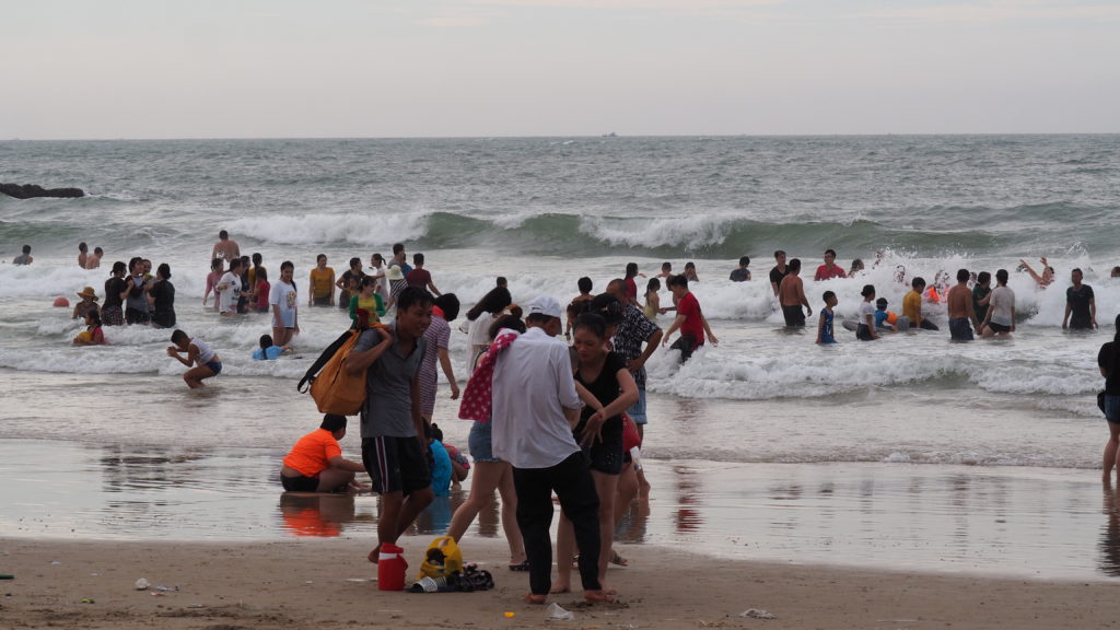 Vietnamese tourists spending their leisure time at the beach of Tuy Phong district
