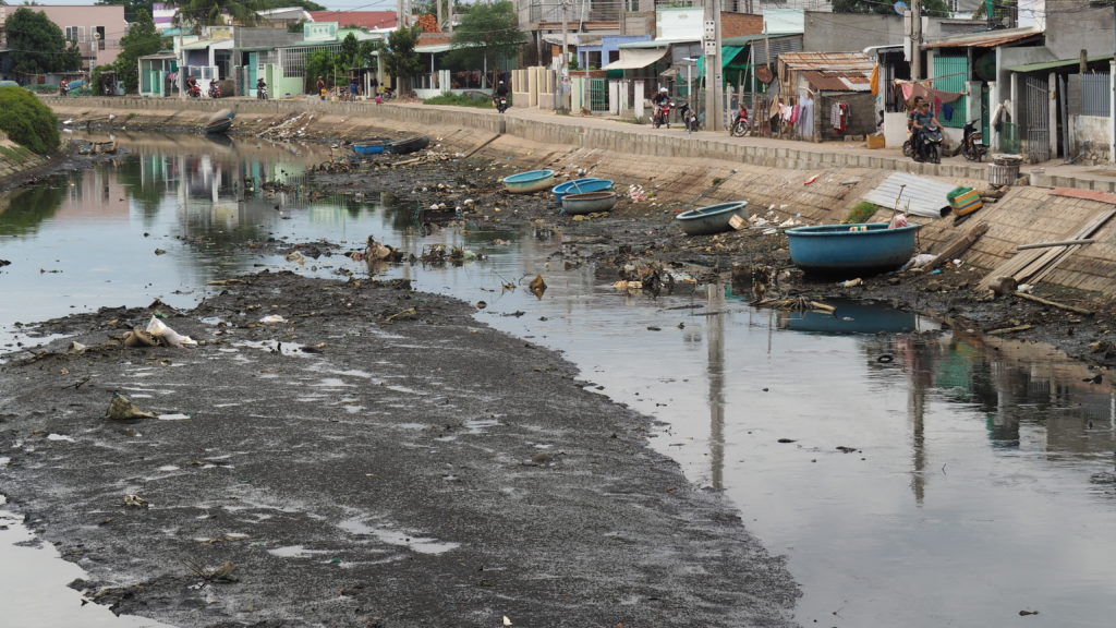 River in Phan Rang-Thap Cham with accumulated rubbish and sludge