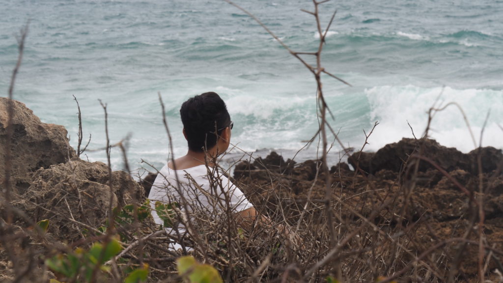 Sayama looking out over the rough sea